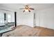 Sunlit room featuring versatile workstations, ample storage, modern lighting and light colored wood flooring at 4682 Stonewall Tell Rd, College Park, GA 30349
