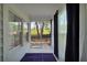 Cozy screened porch with a blue rug, a view of the backyard, and blue curtains at 4682 Stonewall Tell Rd, College Park, GA 30349