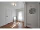Bright room with light wood floors, large window with sheer curtains, modern decor, and white walls at 4682 Stonewall Tell Rd, College Park, GA 30349