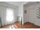 Bright room with light wood floors, large window with sheer curtains, modern decor, and white walls at 4682 Stonewall Tell Rd, College Park, GA 30349