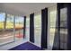 Cozy sunroom with multiple windows and curtains, providing natural light and a relaxing space at 4682 Stonewall Tell Rd, College Park, GA 30349
