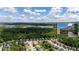 Expansive aerial view showcasing the community, mature trees, and the home, with mountain views in the distance at 5655 Hedge Brook Dr, Cumming, GA 30028