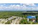 Expansive aerial view showcasing the property's location within a lush, green neighborhood surrounded by trees at 5655 Hedge Brook Dr, Cumming, GA 30028