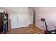 Bedroom with light pink walls, wood floors, and access to a closet at 5655 Hedge Brook Dr, Cumming, GA 30028