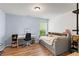Cozy bedroom with light blue walls, wood floors, and a built-in bed at 5655 Hedge Brook Dr, Cumming, GA 30028