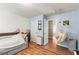 Cozy bedroom featuring hardwood floors, daybed, and unique hammock chair, creating a charming and inviting space at 5655 Hedge Brook Dr, Cumming, GA 30028