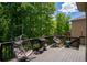 Outdoor deck featuring comfortable chairs, a grill, and a peaceful setting, perfect for relaxation and entertaining at 5655 Hedge Brook Dr, Cumming, GA 30028