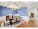 Elegant dining room with hardwood floors, a coffered ceiling, and stylish decor at 5655 Hedge Brook Dr, Cumming, GA 30028