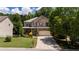 Charming two-story brick home with a covered front porch, well-maintained landscaping, and a welcoming curb appeal at 5655 Hedge Brook Dr, Cumming, GA 30028