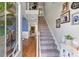 Welcoming foyer featuring hardwood floors, a staircase, and stylish decor at 5655 Hedge Brook Dr, Cumming, GA 30028