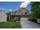 Charming two-story brick home featuring a front porch, attached garage, and a well-manicured lawn at 5655 Hedge Brook Dr, Cumming, GA 30028