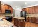 Kitchen featuring dark wood cabinets, stainless steel appliances and granite countertops at 5655 Hedge Brook Dr, Cumming, GA 30028