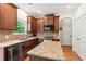 Kitchen boasts granite countertops, dark wood cabinets, and stainless steel appliances at 5655 Hedge Brook Dr, Cumming, GA 30028