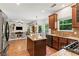 Open kitchen flows to the living room with stainless steel appliances and center island at 5655 Hedge Brook Dr, Cumming, GA 30028