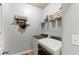 Well-equipped laundry room with washer, dryer, shelving, and modern decor at 5655 Hedge Brook Dr, Cumming, GA 30028