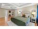 Spacious main bedroom featuring tray ceilings, light wood floors, and a decorative headboard at 5655 Hedge Brook Dr, Cumming, GA 30028