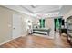 Bright main bedroom with tray ceilings, wood floors, and natural light from the windows at 5655 Hedge Brook Dr, Cumming, GA 30028