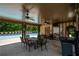 Poolside patio area with ceiling fans, table, and chairs, with a clear view of the refreshing community pool at 5655 Hedge Brook Dr, Cumming, GA 30028