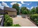 Inviting community pool area with ample seating, surrounded by lush landscaping and shaded by mature trees at 5655 Hedge Brook Dr, Cumming, GA 30028