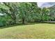 Expansive backyard with lush green grass and mature trees, providing a private and serene outdoor space at 179 Carter Rd, Auburn, GA 30011