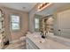 Bright bathroom featuring a large mirror, vanity with marble countertop, and wood-look tile shower at 179 Carter Rd, Auburn, GA 30011