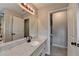 Bathroom featuring a marble countertop vanity, and shower with wood-look tile at 179 Carter Rd, Auburn, GA 30011