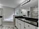 Well-lit primary bathroom featuring soaking tub, large vanity, and walk in shower at 179 Carter Rd, Auburn, GA 30011