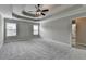 Spacious bedroom with large windows, trey ceilings, ceiling fan and ensuite bathroom at 179 Carter Rd, Auburn, GA 30011