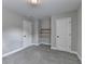 Neutral bedroom with built-in shelves, soft carpet, and white doors for a bright, modern feel at 179 Carter Rd, Auburn, GA 30011