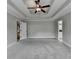 Large bedroom featuring tray ceilings with ceiling fan and ensuite bathroom and closet at 179 Carter Rd, Auburn, GA 30011