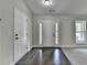 Bright foyer featuring dark wood flooring and a white front door with sidelights at 179 Carter Rd, Auburn, GA 30011