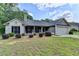 Charming single-story home with gray brick, manicured landscaping, and a two-car garage at 179 Carter Rd, Auburn, GA 30011