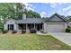 Charming single-story home with gray brick, manicured landscaping, and a two-car garage at 179 Carter Rd, Auburn, GA 30011