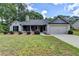 Charming single-story home with gray brick, manicured landscaping, and a two-car garage at 179 Carter Rd, Auburn, GA 30011