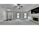 Open living room with fireplace, built-in shelving, and a view of the entryway at 179 Carter Rd, Auburn, GA 30011