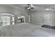 Open-concept living room with neutral carpet and seamless flow to the kitchen and dining areas at 179 Carter Rd, Auburn, GA 30011