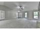 Large, bright living room with neutral carpet and access to multiple rooms at 179 Carter Rd, Auburn, GA 30011