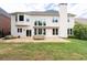 Expansive backyard featuring a stone patio, lush lawn, and a tall brick chimney at 2310 Norbury Se Cv, Smyrna, GA 30080