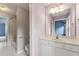 Bright bathroom featuring a large mirror, vanity with white cabinetry, and tiled floors at 2310 Norbury Se Cv, Smyrna, GA 30080
