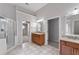 Spacious bathroom featuring double vanities, a shower, and tile flooring at 2310 Norbury Se Cv, Smyrna, GA 30080