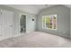 Bedroom with vaulted ceilings, neutral colored walls, carpet, and large window with outside views at 2310 Norbury Se Cv, Smyrna, GA 30080