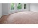 Bright bedroom featuring large windows and neutral carpeting at 2310 Norbury Se Cv, Smyrna, GA 30080