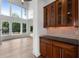 Butler pantry adjacent to living area, featuring hardwood floors, cabinet lighting, and a view to the yard at 2310 Norbury Se Cv, Smyrna, GA 30080