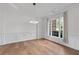 Bright dining room with hardwood floors, modern lighting fixture, and ample natural light at 2310 Norbury Se Cv, Smyrna, GA 30080