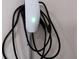 Close up of a Tesla EV charger mounted to the wall in a garage at 2310 Norbury Se Cv, Smyrna, GA 30080