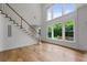 Bright entryway features hardwood floors, a staircase, and a view to the backyard through large windows at 2310 Norbury Se Cv, Smyrna, GA 30080