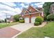 Attractive brick home featuring an attached two-car garage, neatly landscaped front yard, and welcoming curb appeal at 2310 Norbury Se Cv, Smyrna, GA 30080
