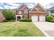 Stately brick home with a two-car garage, well-manicured lawn, and inviting front entrance with columns at 2310 Norbury Se Cv, Smyrna, GA 30080