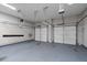 Spacious garage with two car capacity, automatic doors and an electric vehicle charger at 2310 Norbury Se Cv, Smyrna, GA 30080