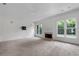 Bright living room with fireplace, large windows, and neutral carpet at 2310 Norbury Se Cv, Smyrna, GA 30080